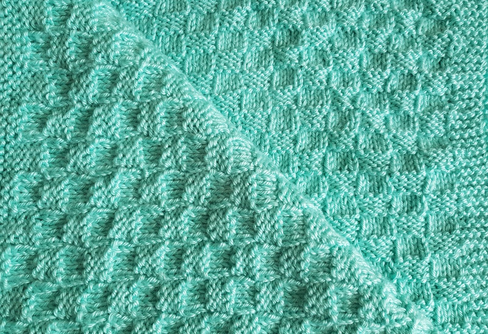 Blog-Inhaltsbild für 'Kostenlose Anleitung für eine Babydecke im Schachbrettmuster – Einfach und Schnell Gestrickt!'