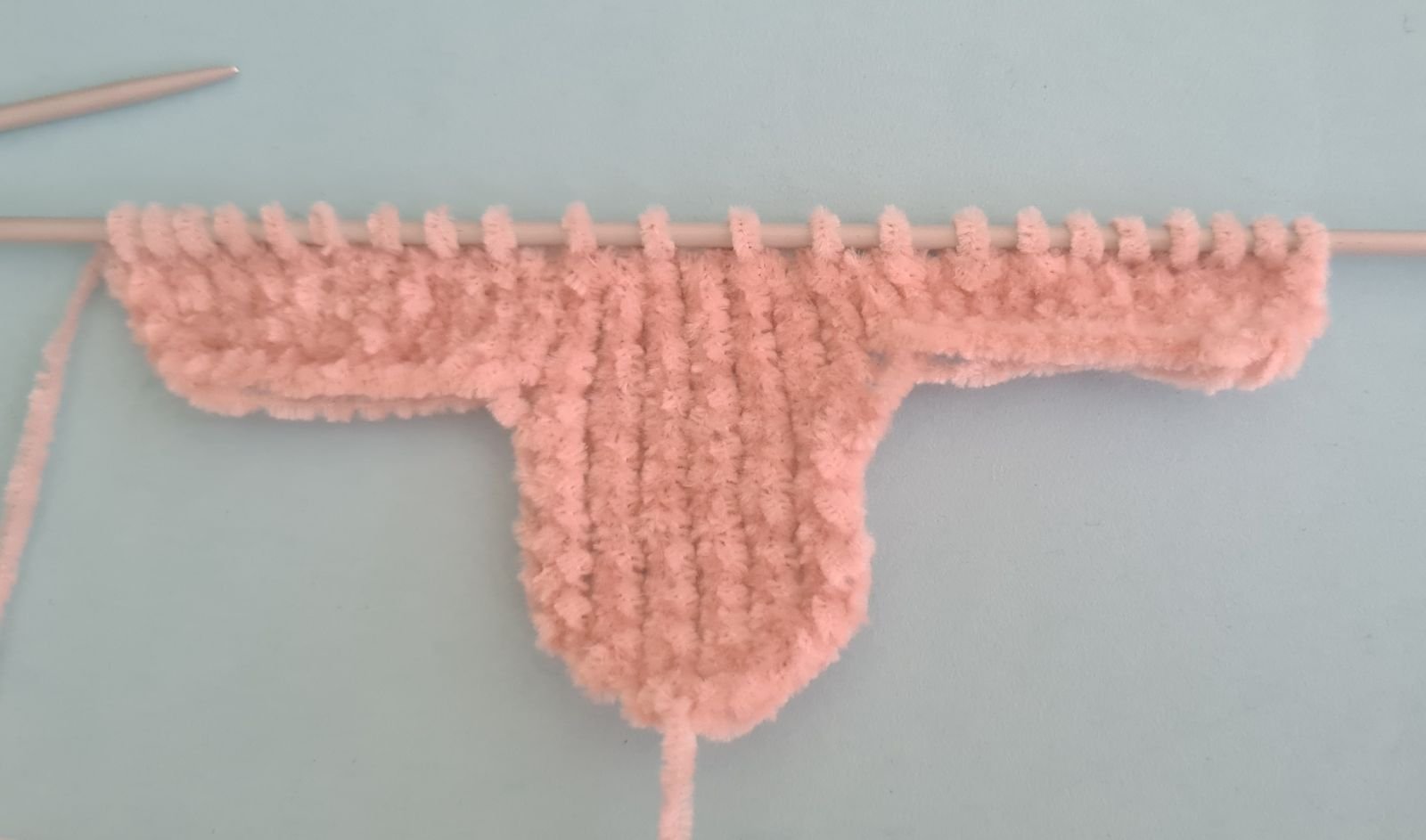 Blog content image for 'A fluffy little baby in a cozy deer, knitted.'