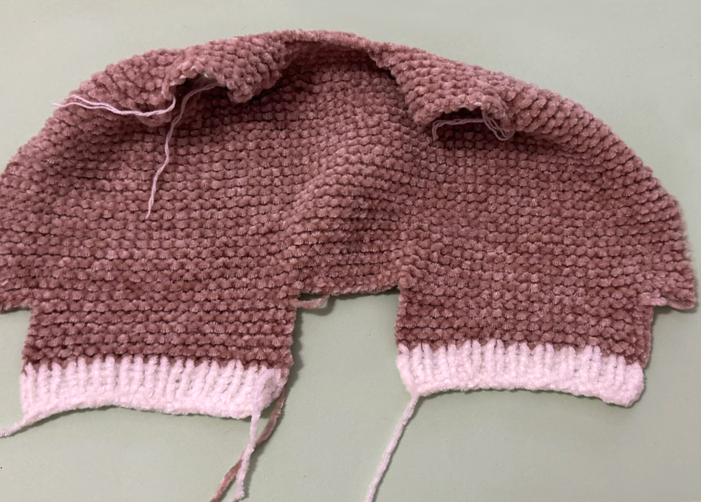 Blog content image for 'A fluffy little baby in a cozy deer, knitted.'