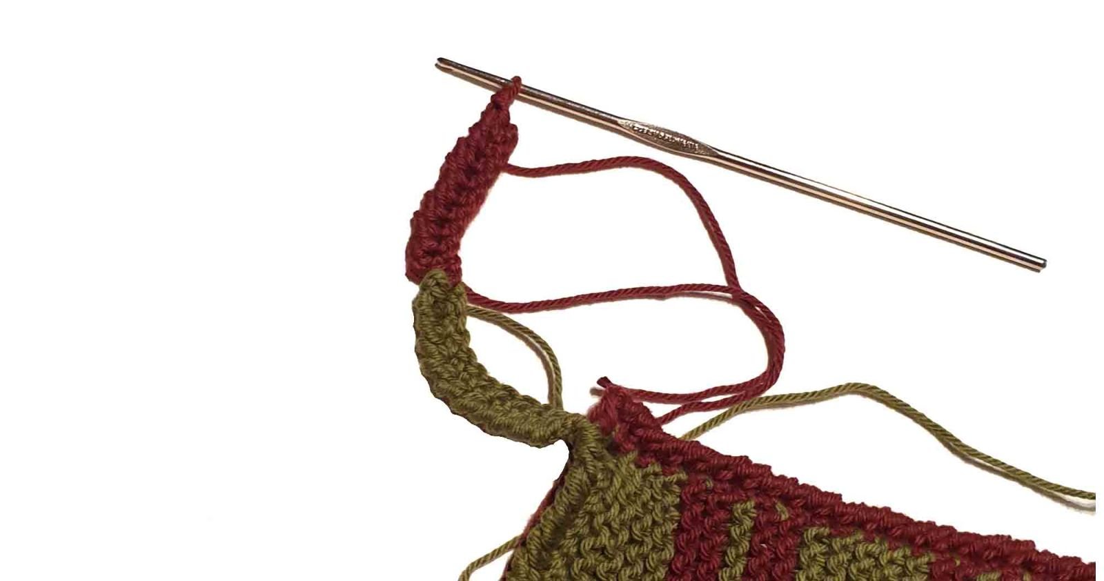 Es wird gezeigt, wie der Aufhänger mit 2 Farben gehäkelt wird.