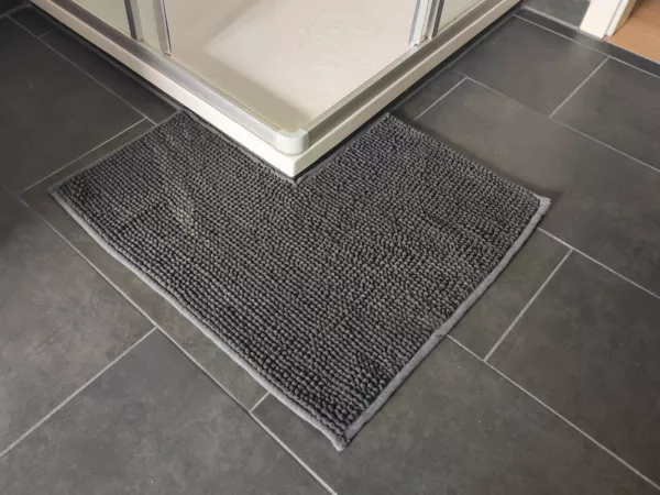 DIY: Turn a Regular Bath Mat into a V-Shaped Rug for Your Corner Shower