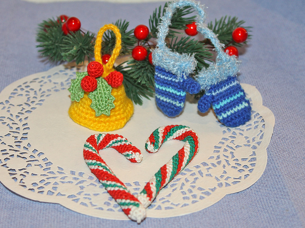 Three Christmas tree decorations made from leftover yarn