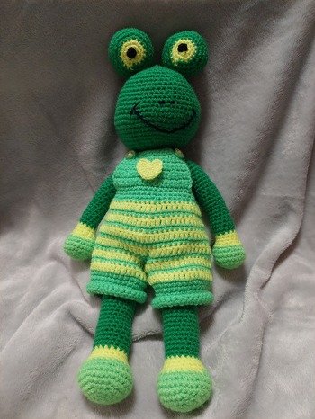 Der Frosch mit Hose ist einfach und schnell zu arbeiten. Von mir aus hat er noch zwei Nasenlöcher bekommen. Die Hosenträger habe ich mit Knöpfen versehen,  anstelle der Blüten. Dafür habe ich im ein Herz auf dem Latz gemacht. Den bekommt jetzt mein Enkel zu seinem Froschbuch.