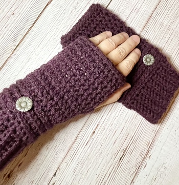 Hand crocheted fingerless texting gloves in plum color with a cute sunflower button. As soon as I make any version of these they sell.