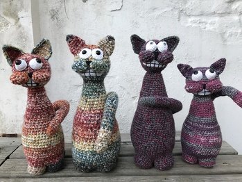 Die Originalwolle hatte ich nicht, aber reichlich andere. So entstanden Colori (nicht auf dem Bild), Trudi und Coloretta (alle aus dem gleichen 6er Garn), Kater Vino (2x4fädige Sockenwolle) und Pinki (6+4-fädige Sockenwolle). Sie wurden alle mit je etwa 1 kg grobem Streusplitt plus Zauberwatte gefüllt. Das Foto entstand bei ihrem Auszug.
