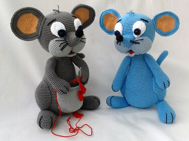 Two amigurumi mice: grey holding a crochet hook and red yarn, blue showing stitch rows and ear shaping