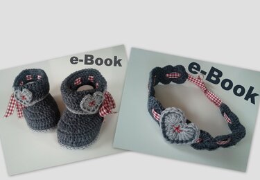 Gehäkelte dunkelgraue Babyschuhe mit hellgrauem Stirnband, kariertes Band und Herzapplikation