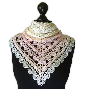 Pastel gradient crocheted triangle shawl on black mannequin