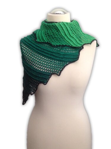 Green gradient asymmetrical crochet shawl draped on a dress form