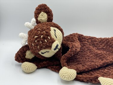Handmade crochet deer snuggle blanket in brown with cream face and small white antlers