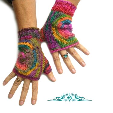 Colorful spiral-striped crocheted fingerless gloves on hands