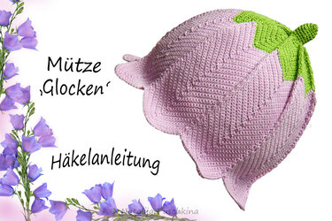 Rosa gehäkelte Babymütze in Glockenform mit grünem Blattabschluss und gezacktem Rand