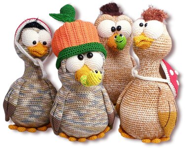 Four crocheted amigurumi birds showing accessory options: pumpkin hat, hood, tiny worms, and a polka-dot backpack