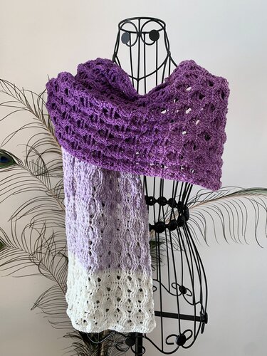 Openwork crochet scarf showing lace stitch pattern and purple-to-white gradient