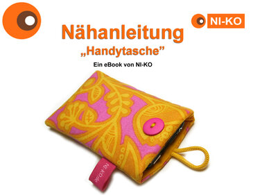 Gelb-pinke Handytasche aus gemustertem Stoff mit pinkem Knopf und gelber Schlaufe auf weißem Hintergrund