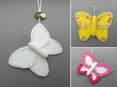Three crocheted butterfly ornaments in white, yellow and pink with bead details, wire antennae and hanging loops