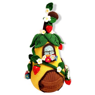 Yellow crocheted fairy house doorstopper with green leaves, red strawberries, small flowers and a blue window.