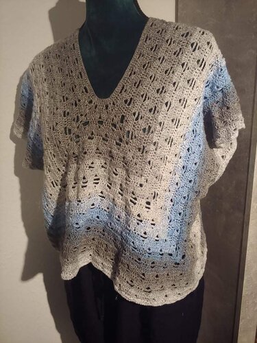 Gehäkeltes Damen-Shirt in Grau und Blau mit V-Ausschnitt und Ajourmuster auf einem Mannequin.