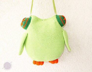 Light green crocheted owl shoulder bag with orange feet and ear accents