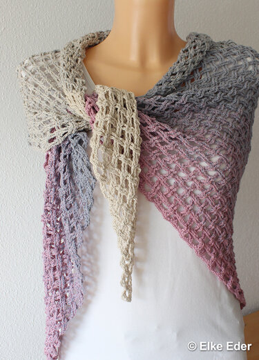 Open-mesh crochet triangle shawl in beige, gray and dusty rose draped on a mannequin