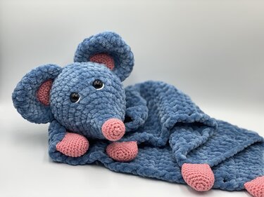 Blue crocheted mouse lovey with pink nose, ears, and paws on a white background.