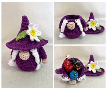 Lila gehäkelter Wichtel mit abnehmbarem Blütenhut, weißen Zöpfen und runder Nase
