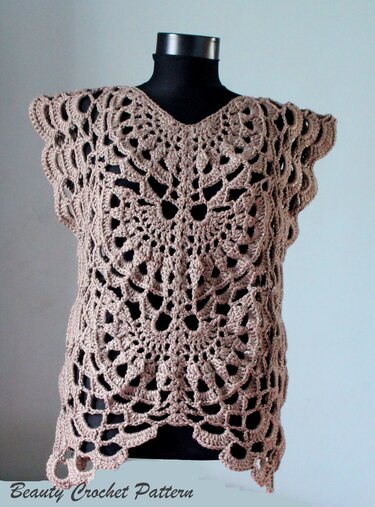 Light brown crocheted top with large lacy pattern, V-neck, and scalloped edges on a black mannequin.