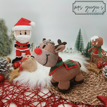 Amigurumi crochet display of Santa Claus, a red-nosed reindeer, and a gingerbread man.
