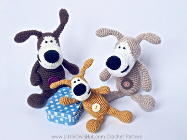 Three crocheted amigurumi dog toys in dark brown, light tan, and golden yellow with white muzzles and button chest accents.