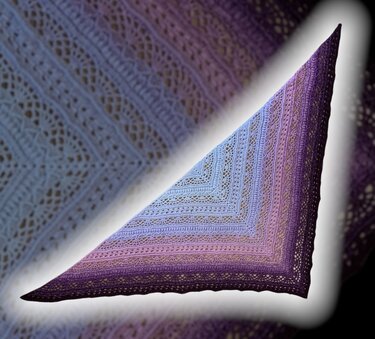 Triangular crochet shawl with blue, lavender, and purple ombre lace pattern