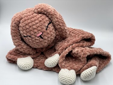 Dusty rose chenille crochet bunny lovey with embroidered closed eyes and white feet