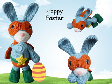 Light-blue crocheted amigurumi rabbit with orange mask and cape next to a striped Easter egg