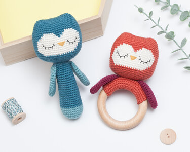 Blue crocheted owl rattle and orange crocheted owl teether with wooden ring.