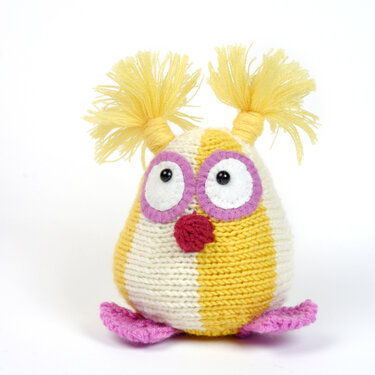 Hand-knitted yellow and white striped amigurumi bird with pink felt eye rings, red beak, pink feet and yellow tassel pigtails