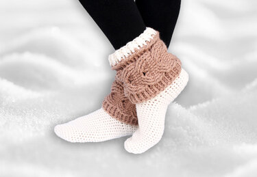Pair of white crochet slipper socks with beige chunky ankle cuffs