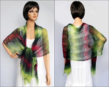 Front and back views of a mannequin wearing a lightweight knitted lace shawl in green, red and black gradient, tied at the front