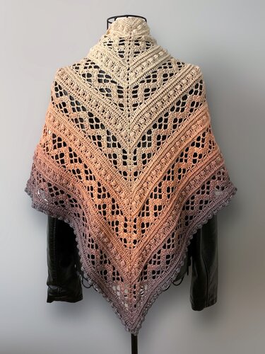 Ombre crochet triangle shawl with V-shaped lace and bobble stitches on a dress form.