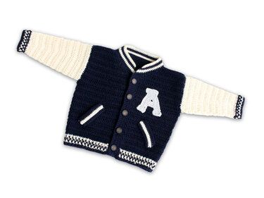 Navy and cream crocheted baby varsity jacket with a light gray letter A appliqué, buttons and pockets on a white background.