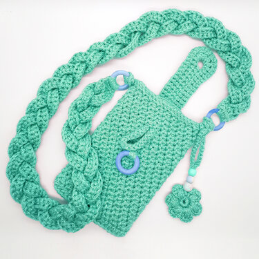Mint crocheted pouch with braided strap, loop closure, blue rings and a flower bead charm