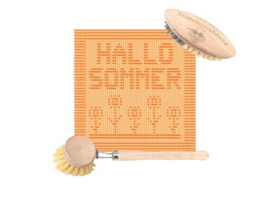 Orange gestricktes Spültuch mit Schriftzug ‚Hallo Sommer‘ und Blumen, neben zwei Holzbürsten.