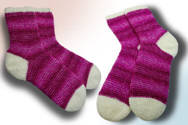 Pair of pink gradient crochet ankle socks with cream toes, heels, and cuffs