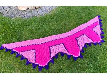 Gehäkeltes Dreieckstuch in Pink und Violett mit Zackenrand auf Wiese