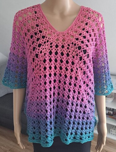 Gehäkeltes Damen-Shirt in Pink, Lila und Türkis mit Ombré-Verlauf und offenem Lochmuster auf Schaufensterpuppe