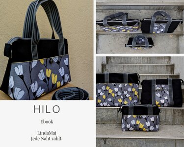 Drei Stofftaschen mit floralem Muster in Grau, Gelb und Weiß, schwarzem Grundstoff und gestreiften Henkeln, auf Treppen und einem Tisch arrangiert.