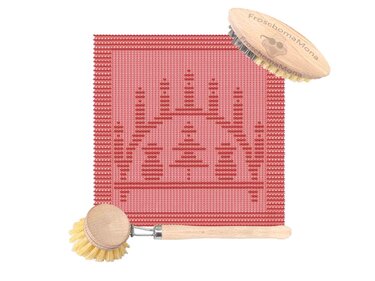 Rotes Strickdeckchen mit stilisiertem Kerzenmotiv