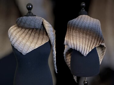 Two views of a triangle crochet shawl on black mannequins, grey-to-beige gradient with diagonal textured stitches.