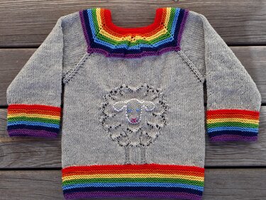 Children's grey knit sweater with rainbow stripes and central lace sheep motif