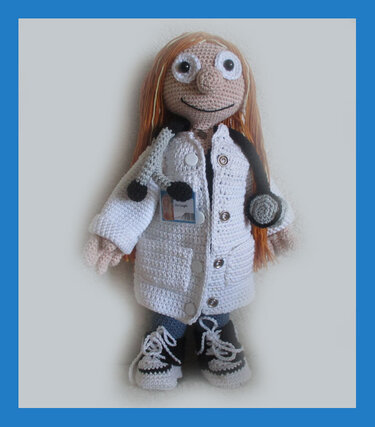 Crocheted amigurumi doll with long red hair wearing a white lab coat and a stethoscope