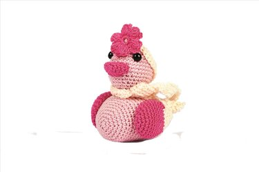 Gehäkeltes Amigurumi-Küken in Rosa und Creme mit dunkelrosa Blume und hellem Schal