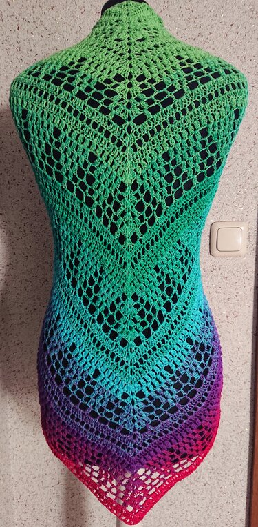 Gehäkeltes Dreieckstuch mit Farbverlauf von Grün bis Rot und V‑förmigem Lochmuster auf Schaufensterpuppe